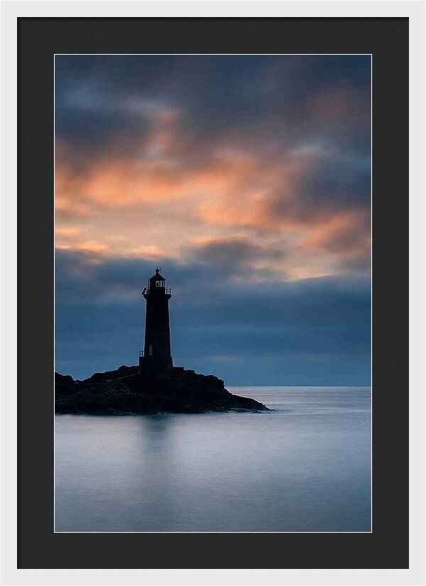 Lighthouse Silhouetted Against Dramatic Sky