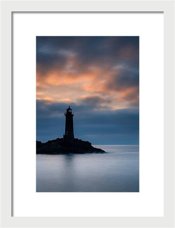 Lighthouse Silhouetted Against Dramatic Sky