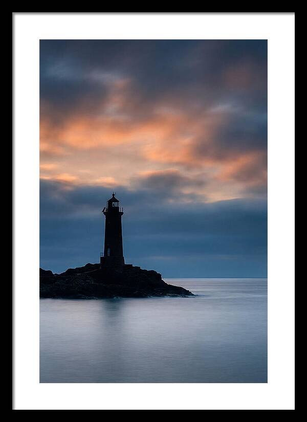 Lighthouse Silhouetted Against Dramatic Sky