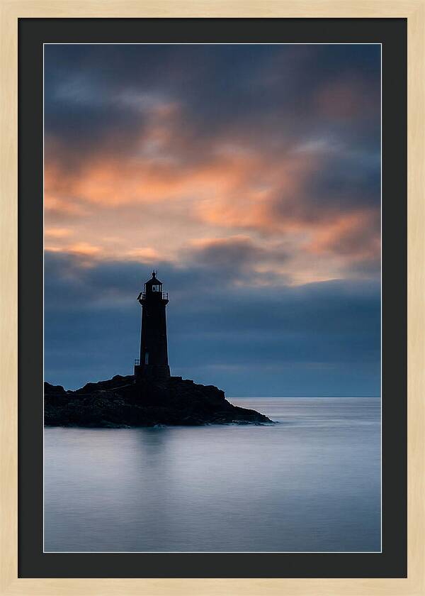 Lighthouse Silhouetted Against Dramatic Sky