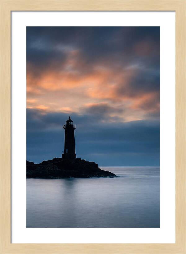 Lighthouse Silhouetted Against Dramatic Sky