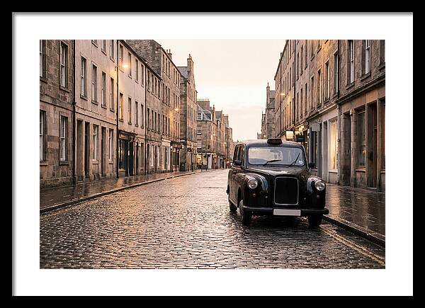 Old British Taxi Cab On Wet Street