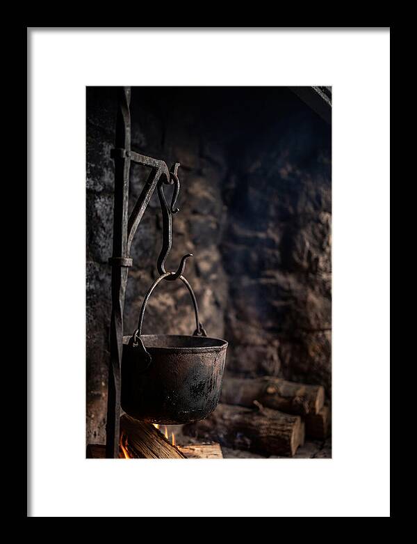 Old Iron Cauldron Hanging In Kitchen
