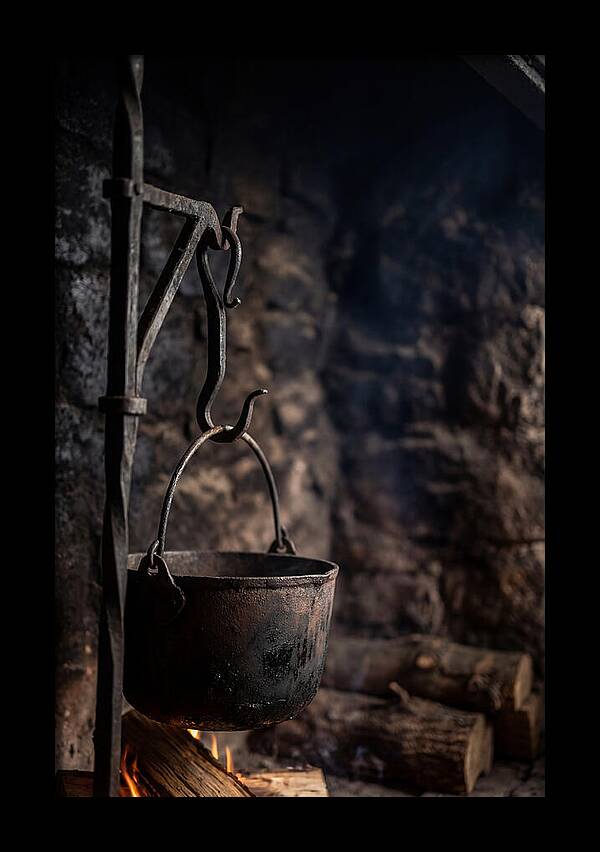 Old Iron Cauldron Hanging In Kitchen
