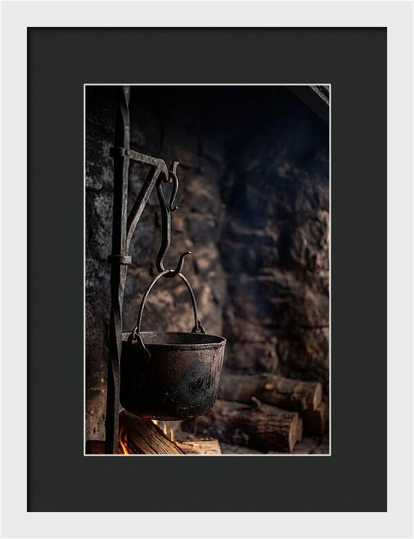 Old Iron Cauldron Hanging In Kitchen