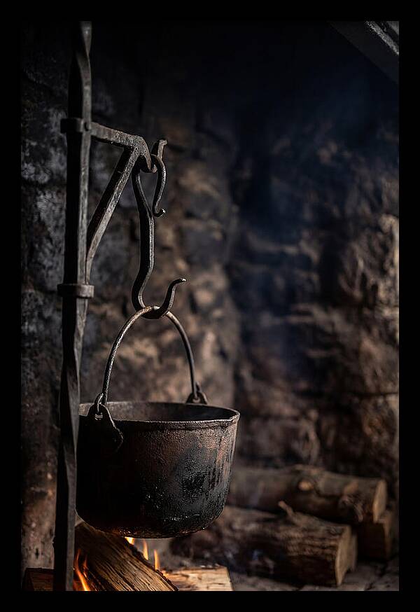 Old Iron Cauldron Hanging In Kitchen