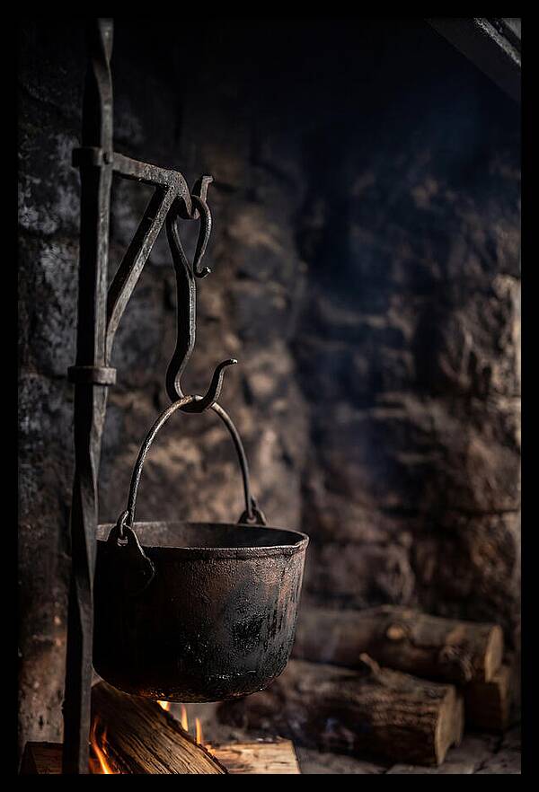 Old Iron Cauldron Hanging In Kitchen