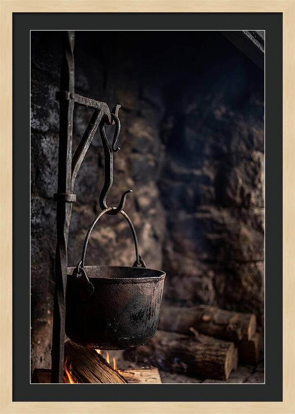 Old Iron Cauldron Hanging In Kitchen