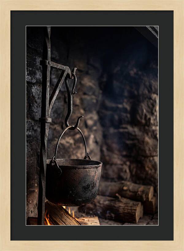 Old Iron Cauldron Hanging In Kitchen