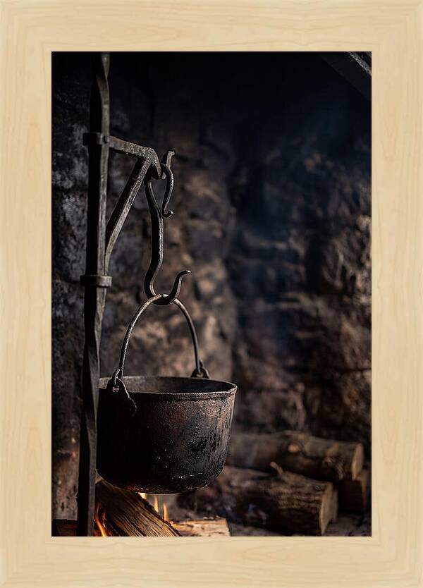 Old Iron Cauldron Hanging In Kitchen