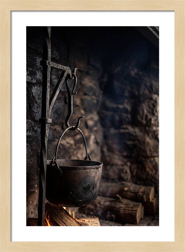Old Iron Cauldron Hanging In Kitchen