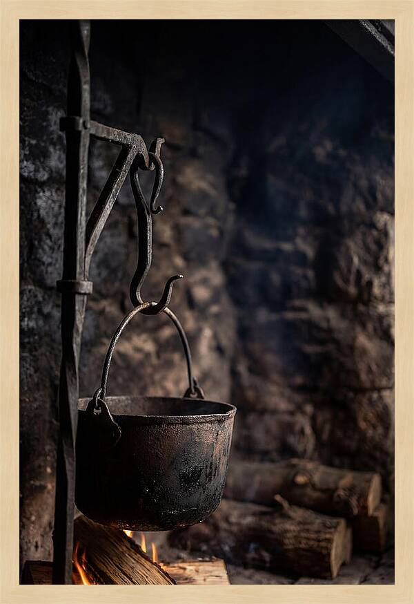 Old Iron Cauldron Hanging In Kitchen