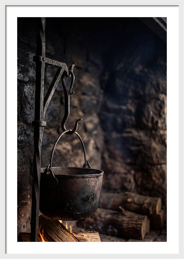Old Iron Cauldron Hanging In Kitchen