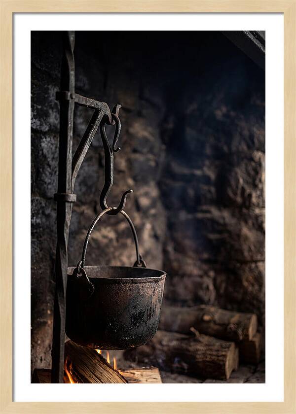 Old Iron Cauldron Hanging In Kitchen