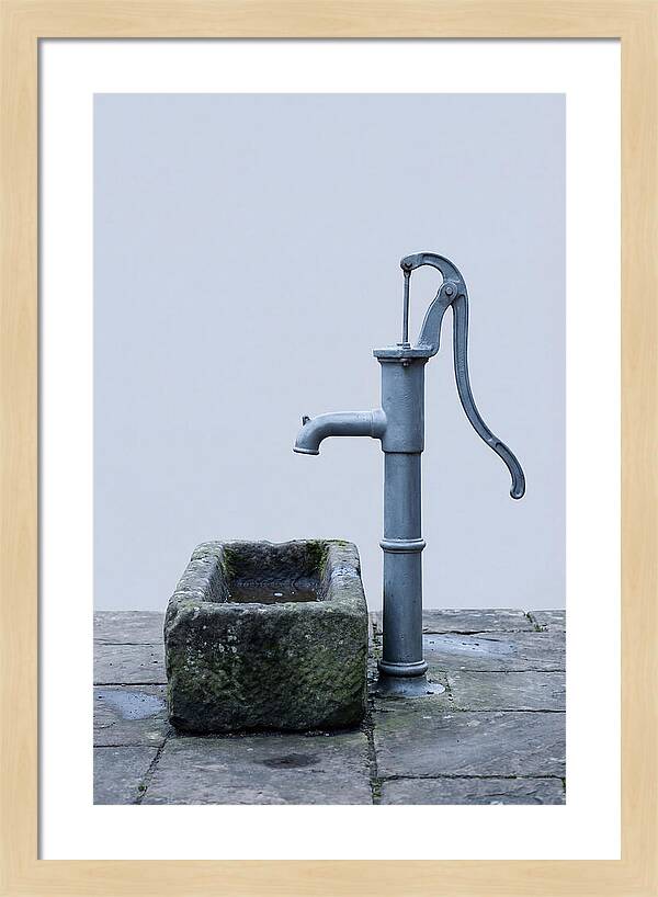 Old Iron Pump Beside Stone Trough