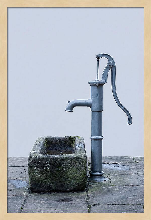 Old Iron Pump Beside Stone Trough