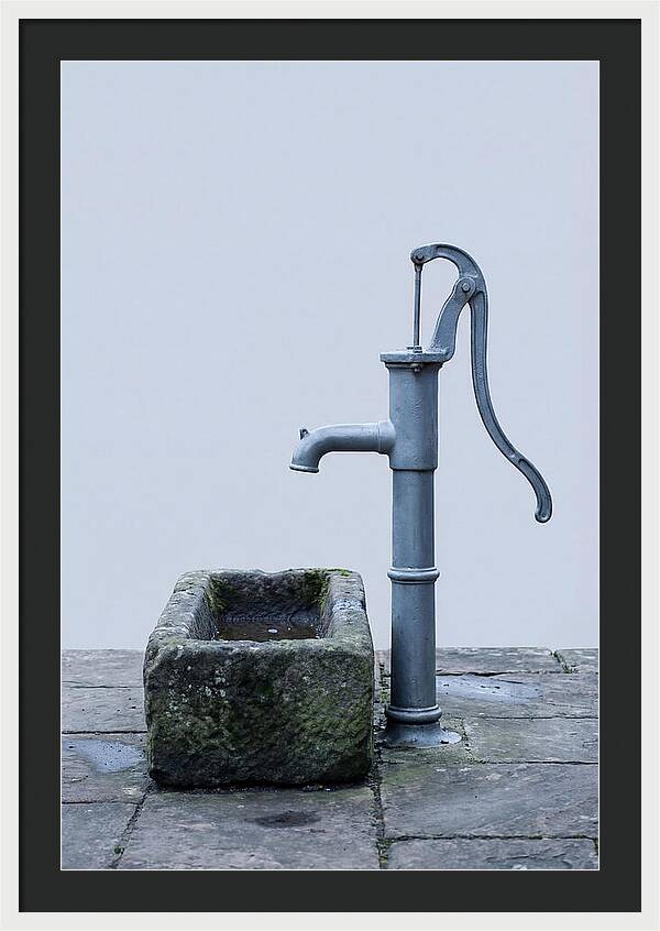 Old Iron Pump Beside Stone Trough