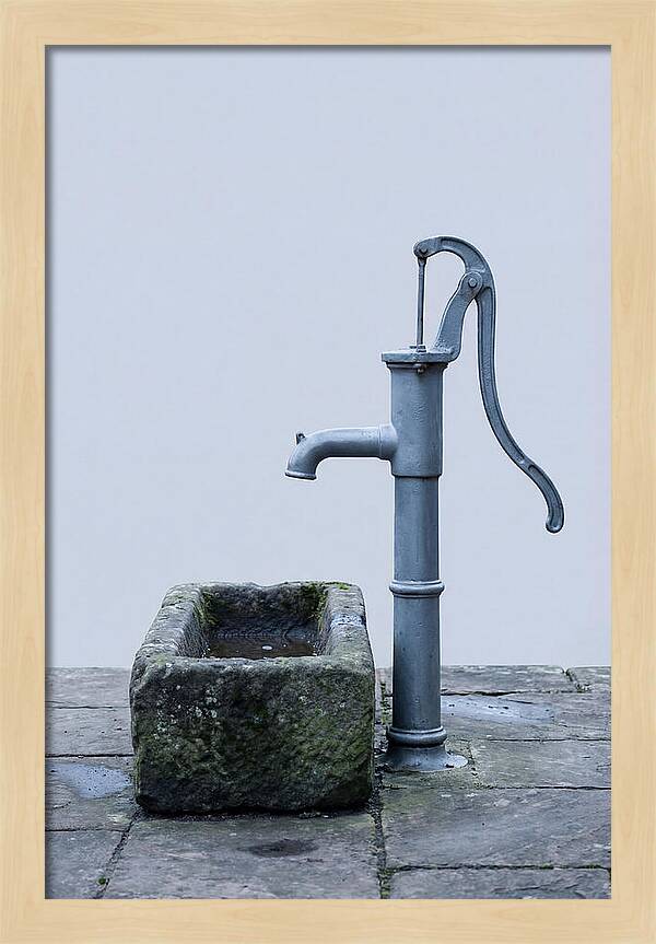 Old Iron Pump Beside Stone Trough