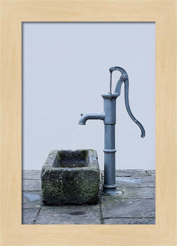 Old Iron Pump Beside Stone Trough