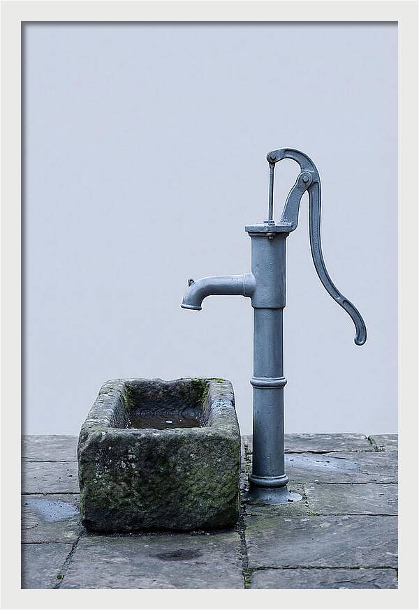Old Iron Pump Beside Stone Trough