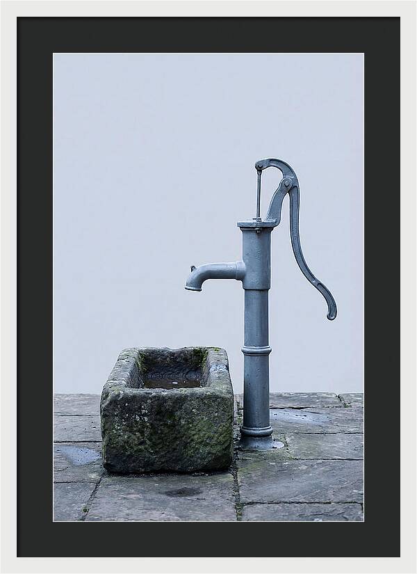 Old Iron Pump Beside Stone Trough
