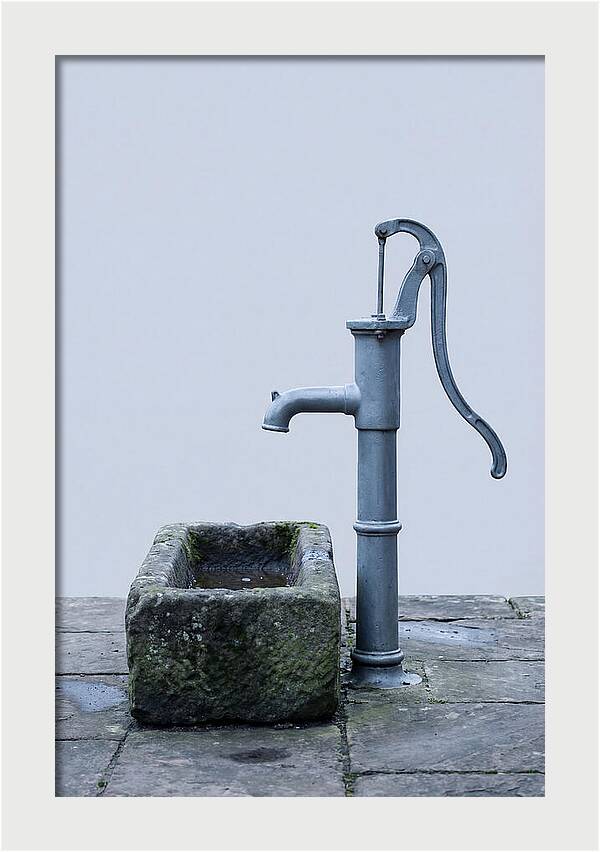 Old Iron Pump Beside Stone Trough
