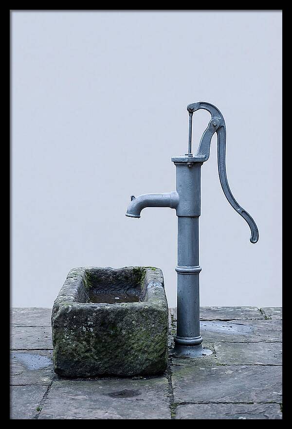 Old Iron Pump Beside Stone Trough