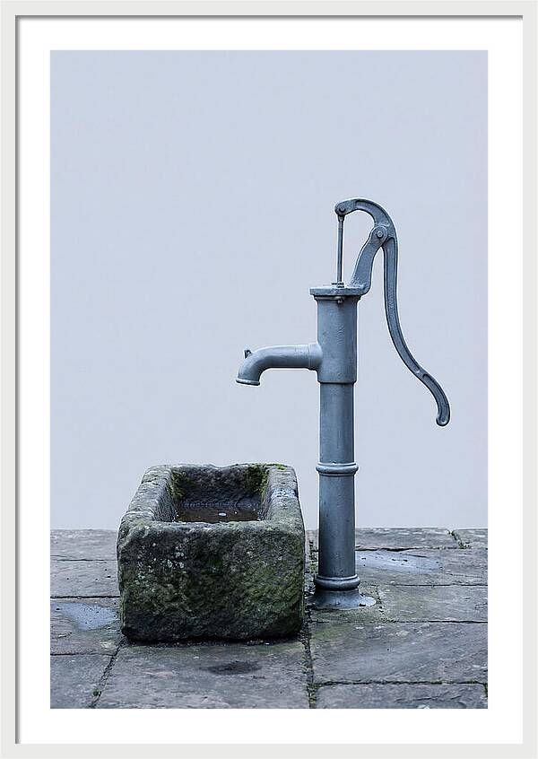 Old Iron Pump Beside Stone Trough