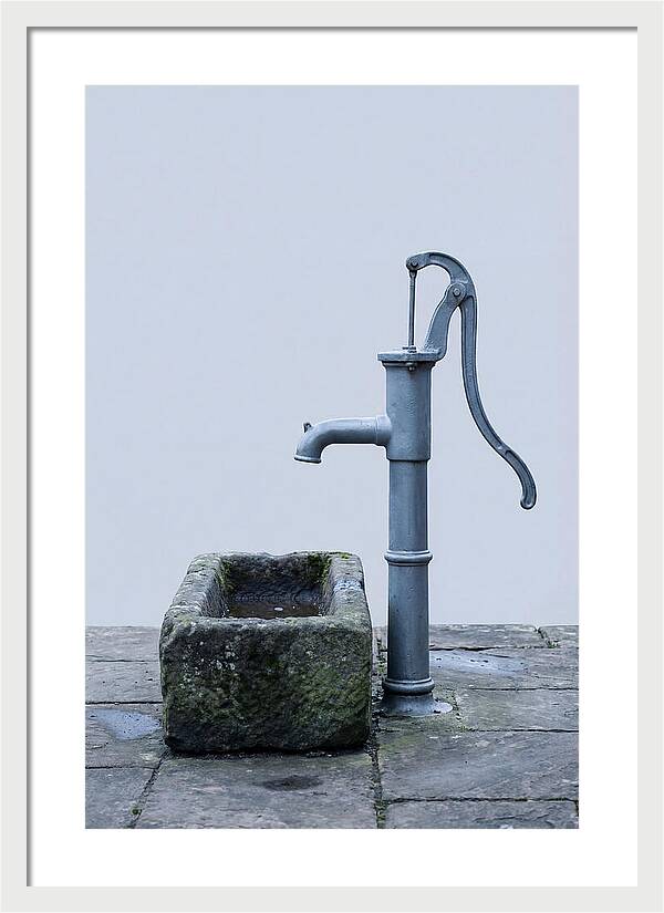 Old Iron Pump Beside Stone Trough