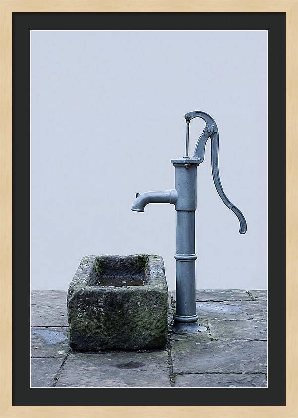 Old Iron Pump Beside Stone Trough