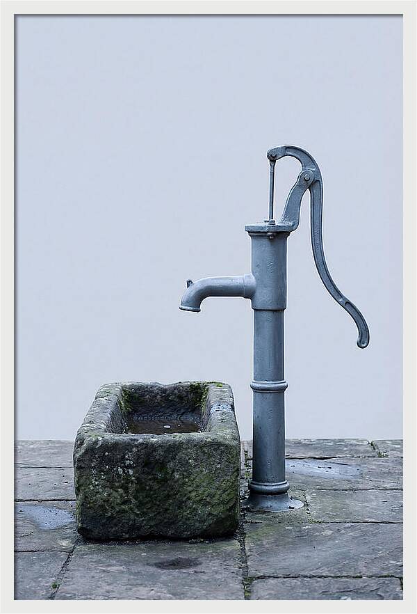Old Iron Pump Beside Stone Trough