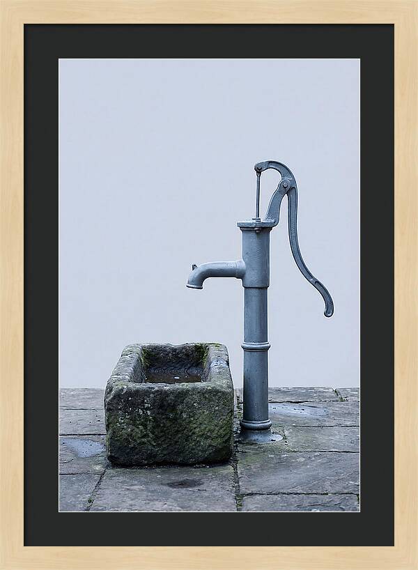 Old Iron Pump Beside Stone Trough