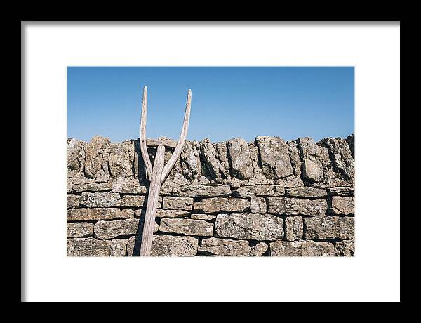 Old Wooden Hay Fork Against Stone Wall