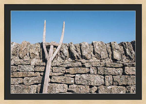 Old Wooden Hay Fork Against Stone Wall