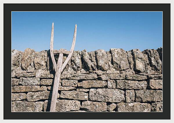 Old Wooden Hay Fork Against Stone Wall