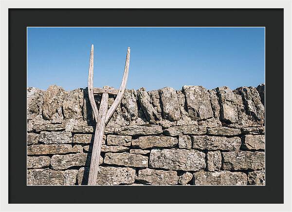 Old Wooden Hay Fork Against Stone Wall