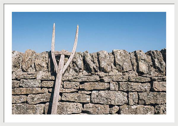 Old Wooden Hay Fork Against Stone Wall