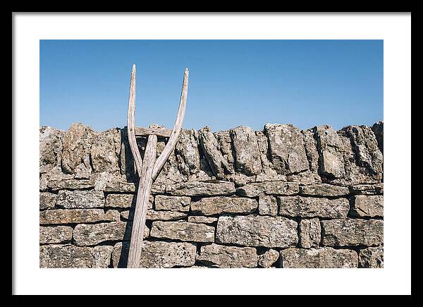 Old Wooden Hay Fork Against Stone Wall