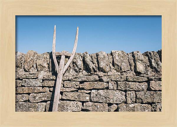 Old Wooden Hay Fork Against Stone Wall