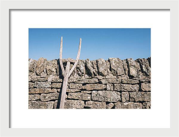 Old Wooden Hay Fork Against Stone Wall