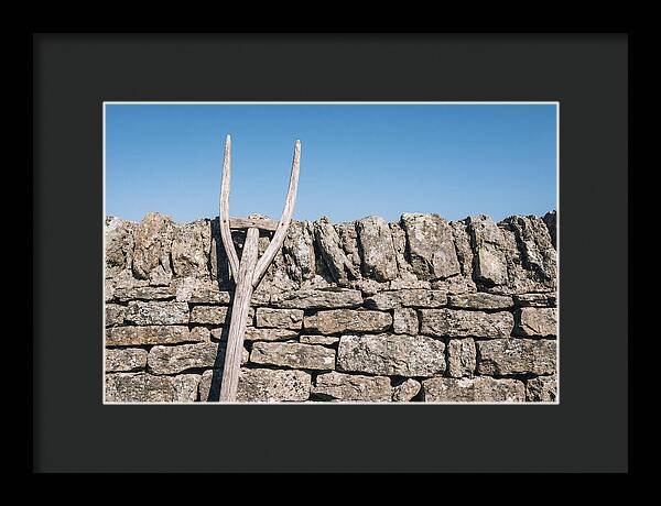 Old Wooden Hay Fork Against Stone Wall