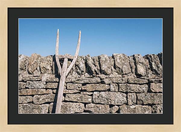 Old Wooden Hay Fork Against Stone Wall