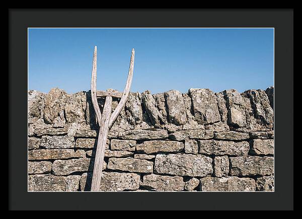 Old Wooden Hay Fork Against Stone Wall