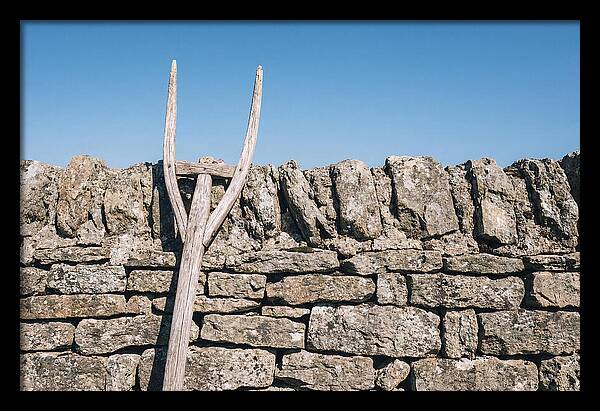Old Wooden Hay Fork Against Stone Wall
