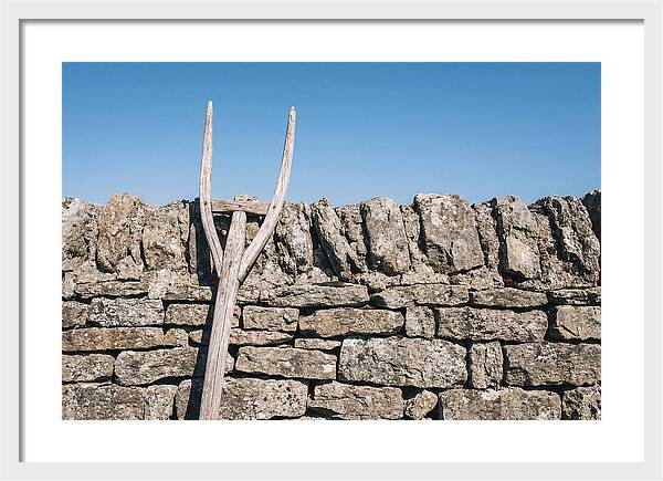 Old Wooden Hay Fork Against Stone Wall