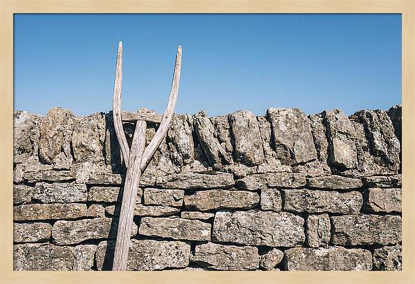 Old Wooden Hay Fork Against Stone Wall