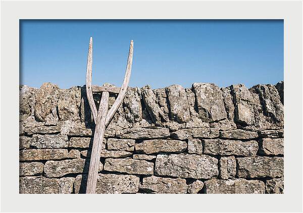Old Wooden Hay Fork Against Stone Wall