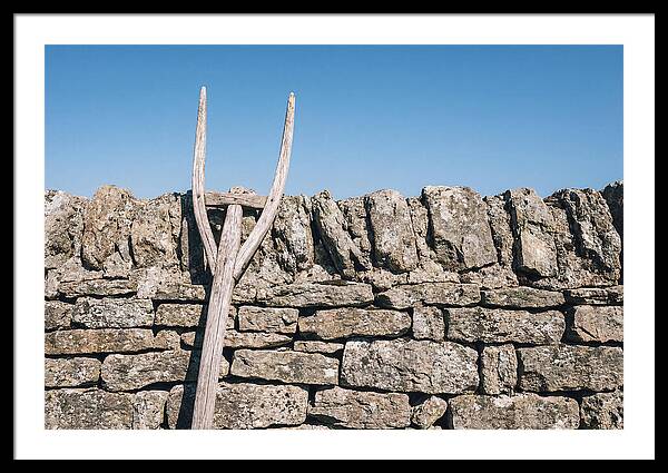 Old Wooden Hay Fork Against Stone Wall