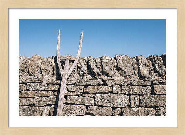 Old Wooden Hay Fork Against Stone Wall