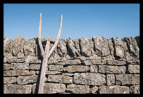 Old Wooden Hay Fork Against Stone Wall